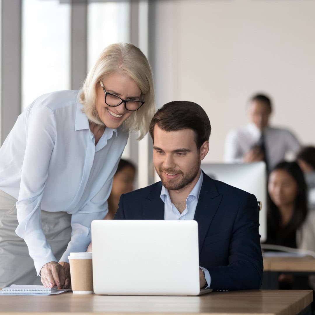 Supportive business coaching and professional development in a corporate office setting.